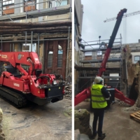 Mini grua aranha apoia demolição de edifício